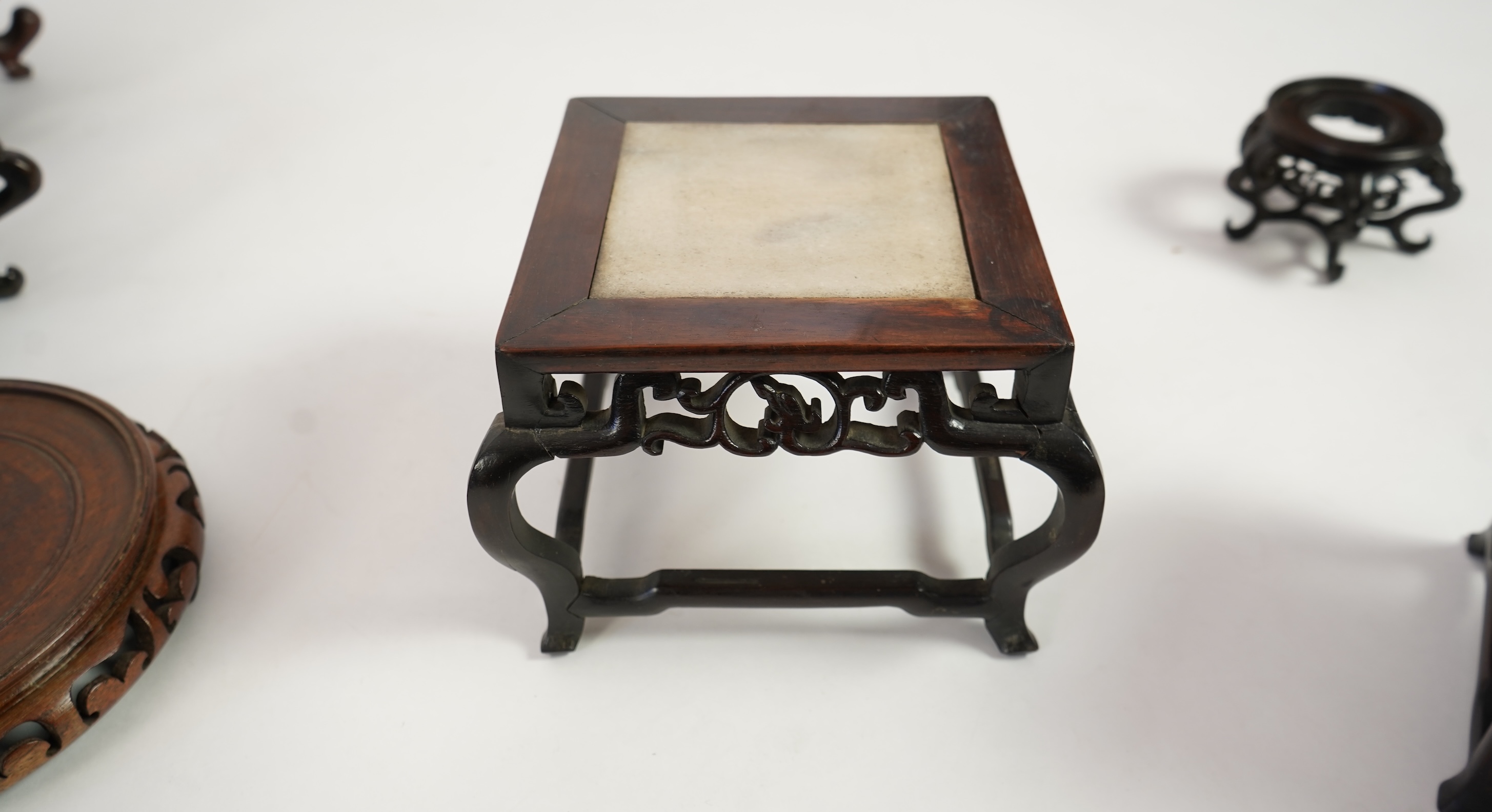 A group of sixteen Chinese hardwood stands together with a Japanese stand, 19th/20th century